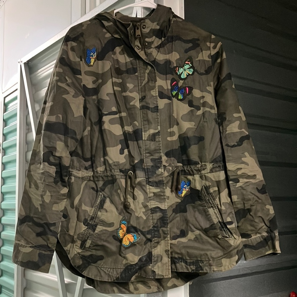 Hooded camo jacket with colorful butterfly patches. Perfect for Fall